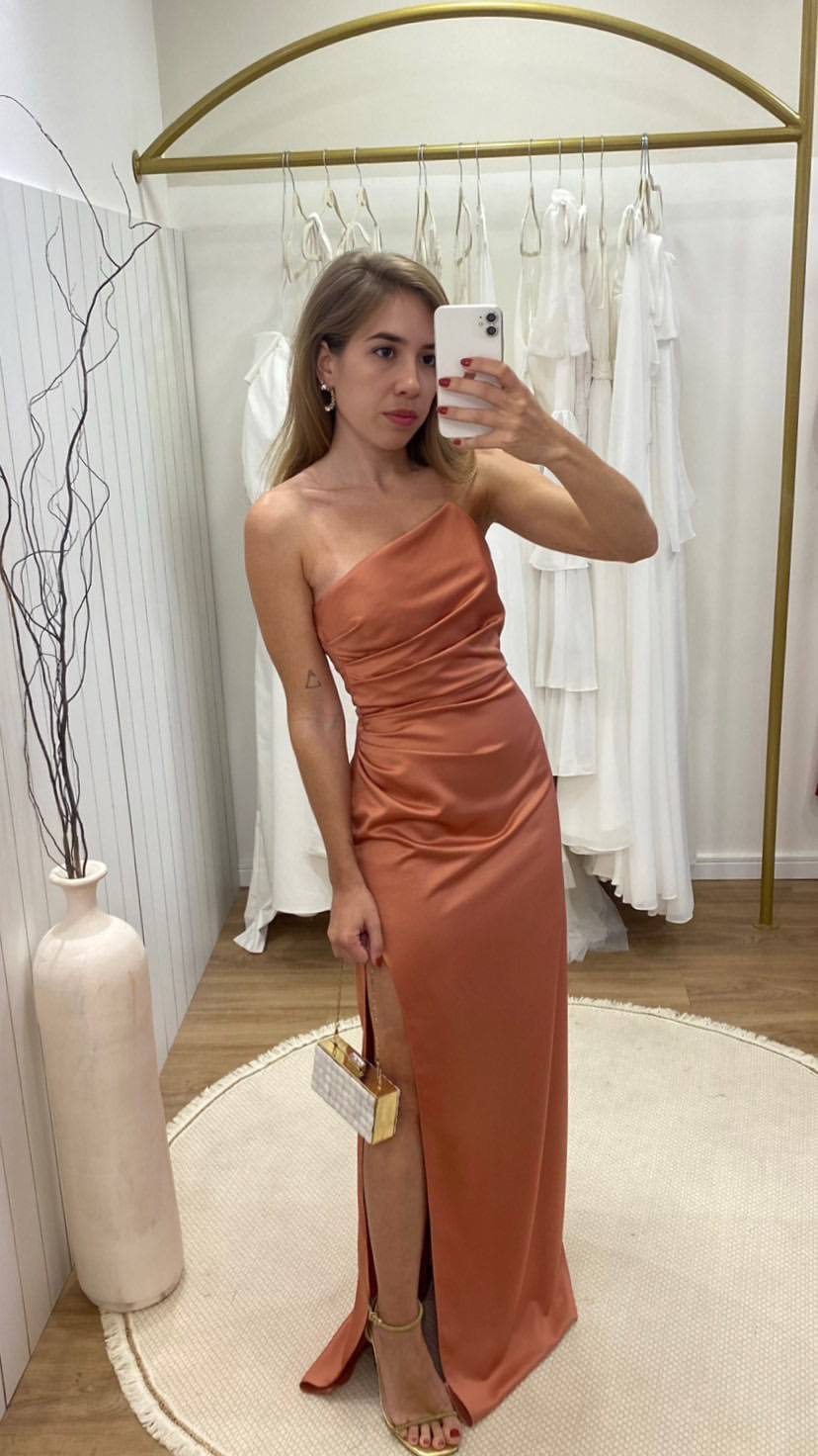 Vestido longo terracota em cetim, modelo um ombro com corpo drapeado e fenda lateral.