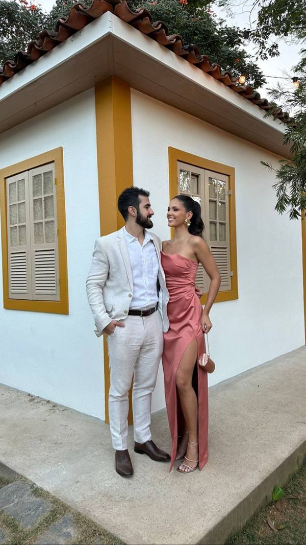 Vestido longo rosé de cetim, tomara que caia, com drapeado no busto e fenda alta na saia.